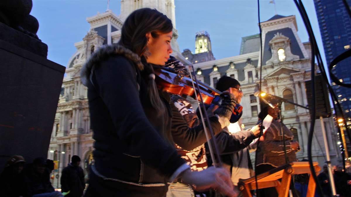Shandi Beardsley plays Pachebel's Canon in D Minor as volunteers step to the microphone to read off the names of the homeless who died in 2013. (Emma Lee/for NewsWorks)