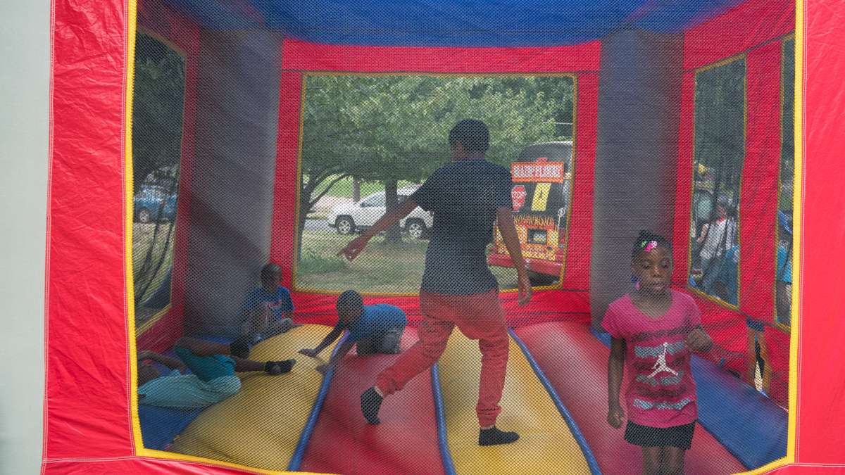 Kids jump in a bounce house