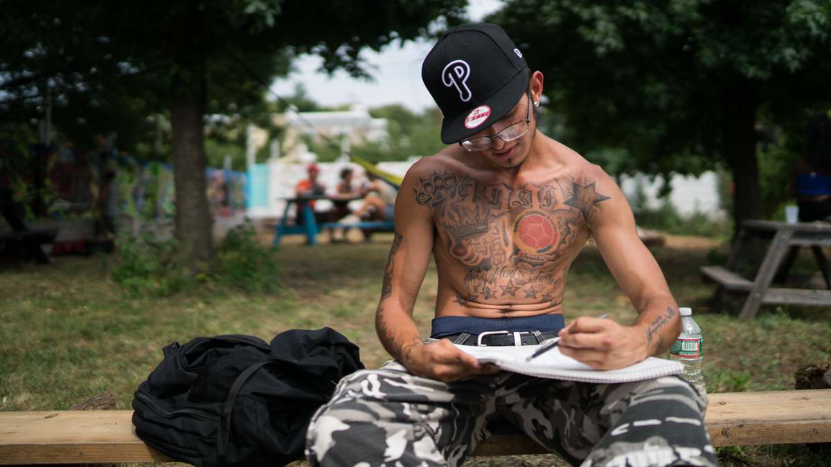 Artist Brayan Leal-Castillo works on a drawing at the 4th annual Hoodstock Festival in North Philadelphia on July 22, 2017.