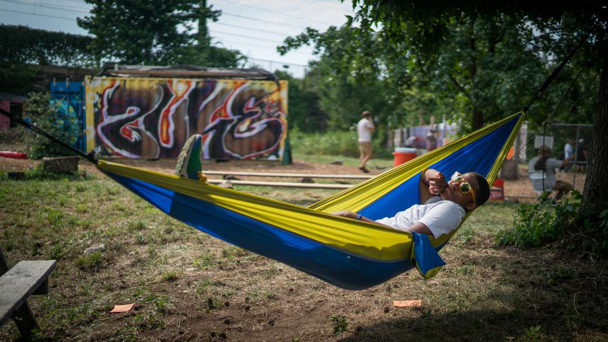 Daiquan Green relaxes in a hammock at the 4th annual Hoodstock Festival in North Philadelphia on July 22, 2017.