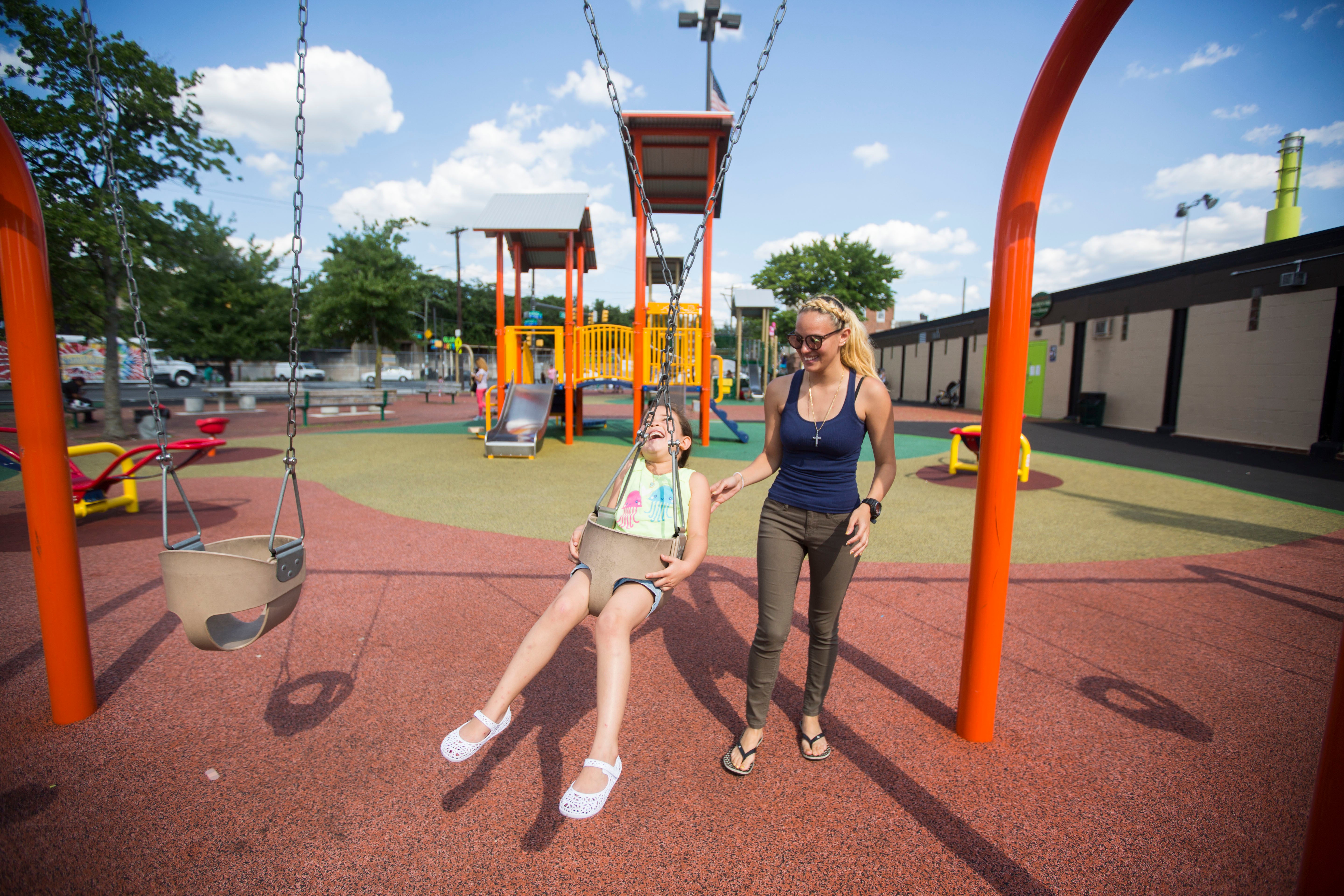 Savannah Zayas and her daughter Layla travel miles from home to find a safe, clean playground. (Jessica Kourkounis/For Keystone Crossroads)