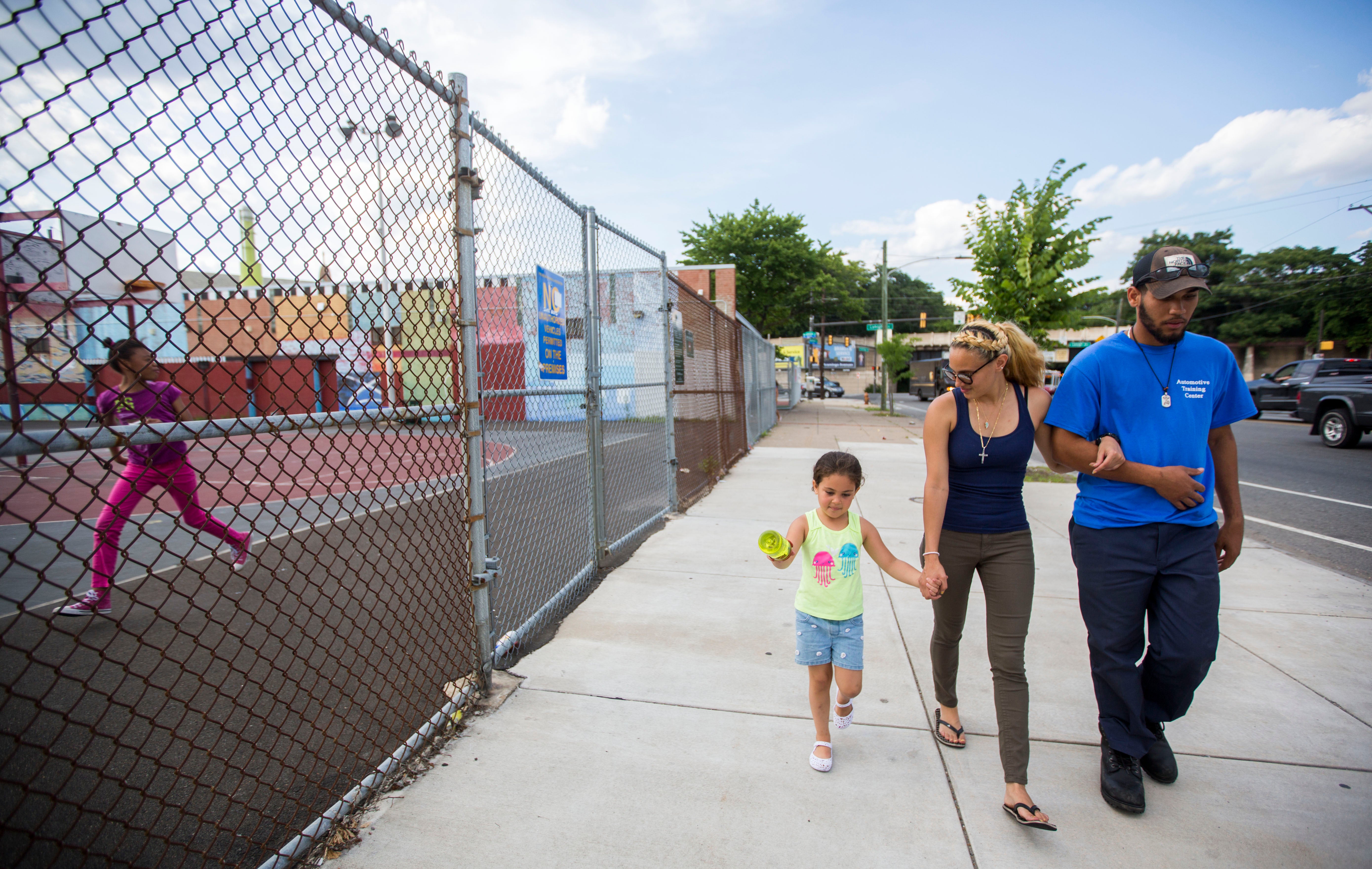 Savannah and Layla walk with Luis Felix (right), who hopes to become a mechanic. (Jessica Kourkounis/For Keystone Crossroads)