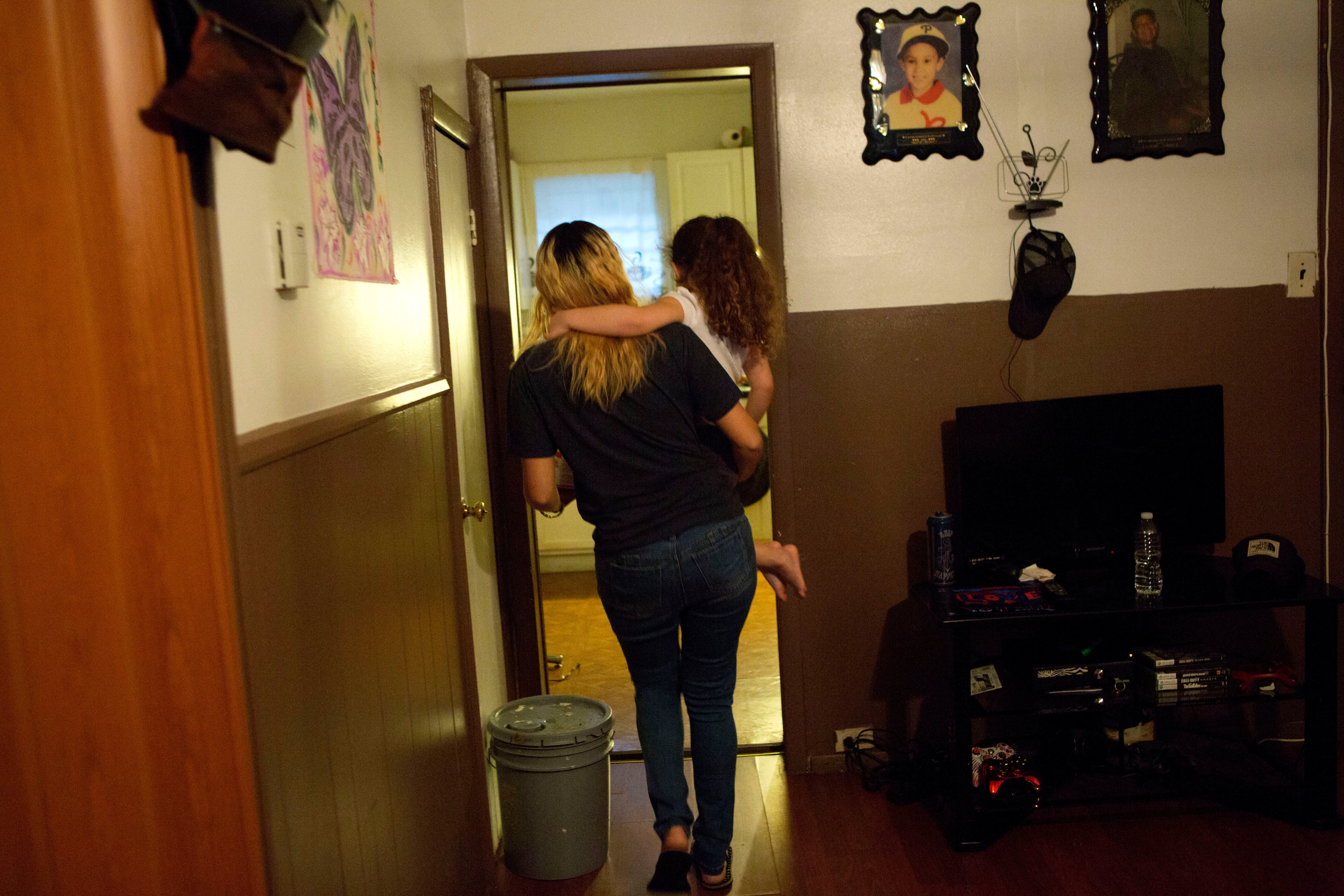 </b> Savannah carries Layla into the kitchen of their Kensington home. (Jessica Kourkounis/For Keystone Crossroads)