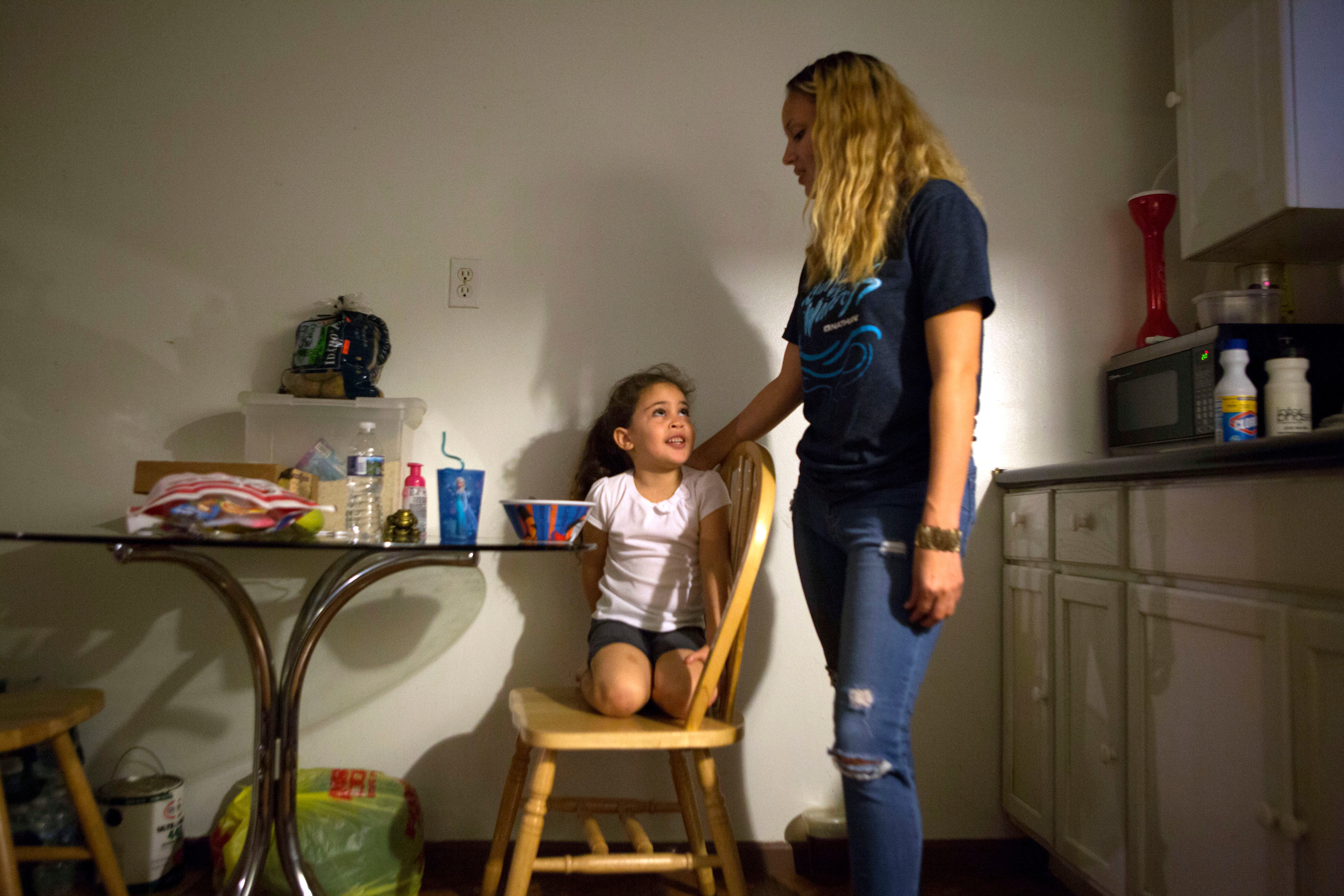 </b> Savannah and Layla in the kitchen of the family’s Kensington home. (Jessica Kourkounis/For Keystone Crossroads)