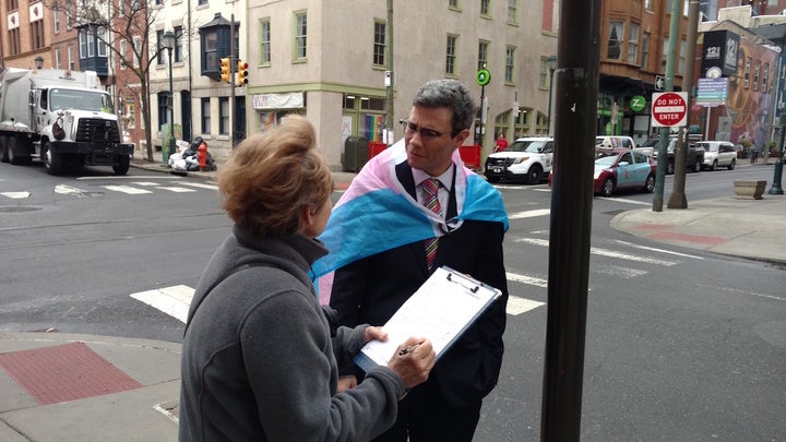 Henry Sias, a Democratic candidate for Common Pleas judge in Philadelphia, gets a passer-by to sign his nominating petition. (Katie Colaneri/WHYY) 