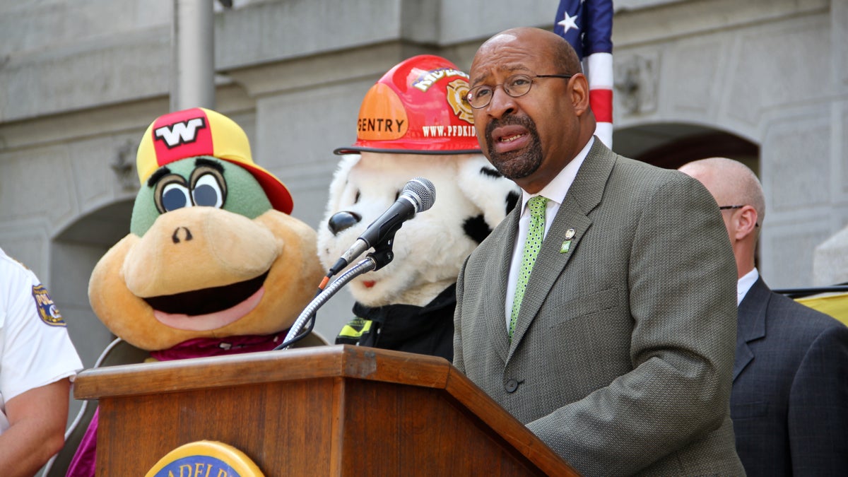 Mayor Michael Nutter, joined by Philadelphia Fire Department mascot Gentry and Wally the Shelter-in-Place Turtle, proclaims September Emergency Preparedness Month. (Emma Lee/WHYY)