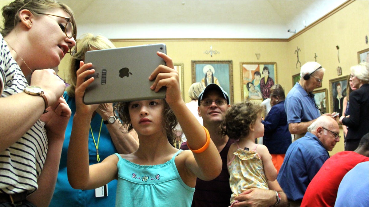Zoe Levenstien, 6,  of Philadelphia uses a new app to scan the walls at the Barnes Foundation. (Emma Lee/WHYY)