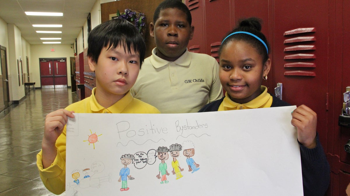  As part of CHOP's anti-bullying program, Childs Elementary fourth-graders (from left) Tuong Truong, Jabree Coleman and Sydney Hall made posters to show what they've learned. (Emma Lee/for NewsWorks) 