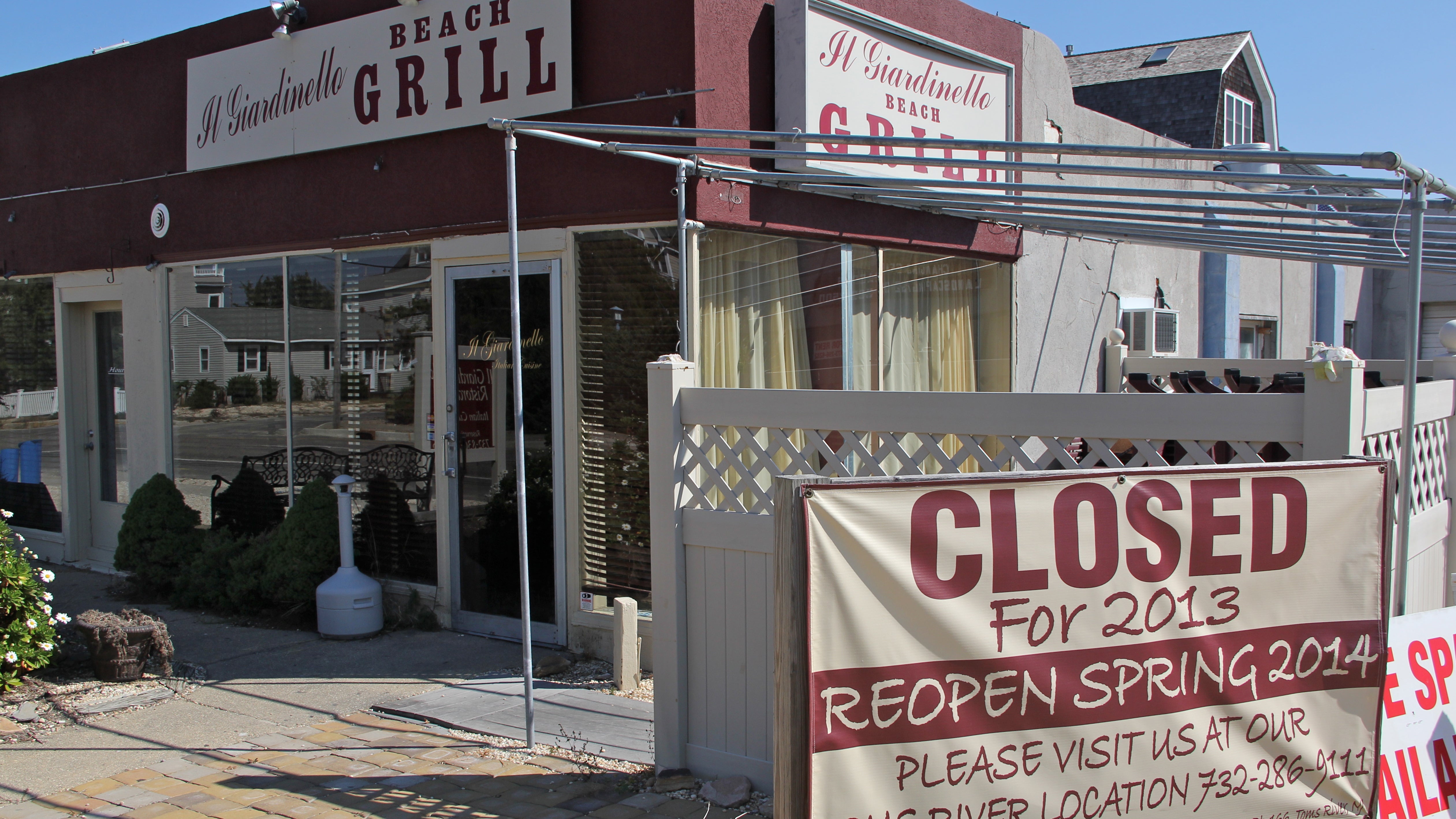  Although a sign says Il Giardinello will reopen in 2014, owners Joe and Colleen Pisacreta are not sure they will be able to restore their Normandy Beach restaurant, damaged by Hurricane Sandy. (Emma Lee/for NewsWorks) 