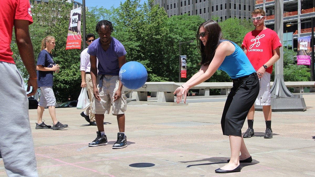Passersby rotate in and out of a game of four square at Paine Plaze. Philadelphia Playworks also broght recess to Comcast Plaza and The Porch at 30th Street Station. (Emma Lee/for NewsWorks)
