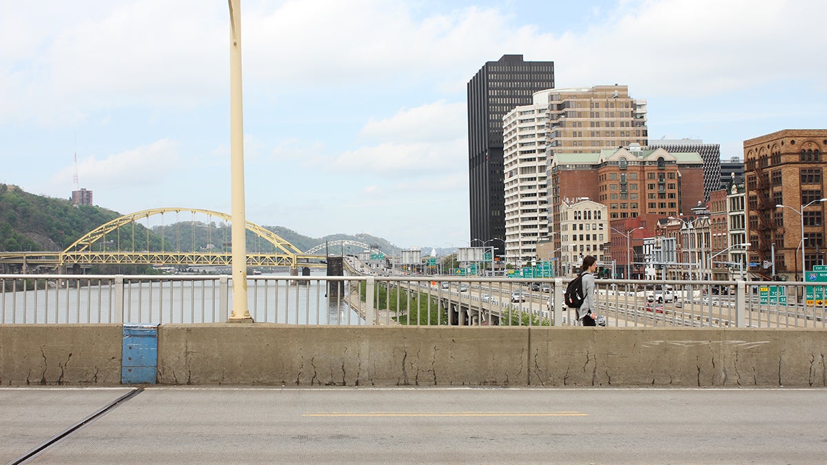  A new ramp will connect the deck of the Smithfield Street Bridge in downtown Pittsburgh with two riverfront trail systems. A long switchback will soften the 40-foot drop between the bridge and the path below. (Margaret J. Krauss/WESA)  
