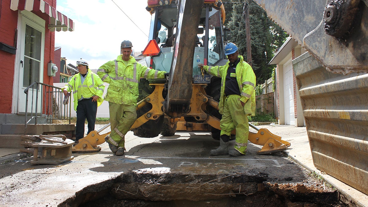  More than 30 percent of Pennsylvania's water systems aren't as resilient as they need to be, according to the Bureau of Safe Drinking Water. Pittsburgh's system has suffered from lack of investment. In the city’s Lawrenceville neighborhood, a Pittsburgh Water and Sewer Authority (PWSA) crew, uncovered and fixed a leaking water main. From left, foreman Mike Gigliotti, Anthony Colapietro, and Eugene Tyler. Joe Ganzer, not pictured, manned the excavator. (Margaret J. Krauss/WESA)  