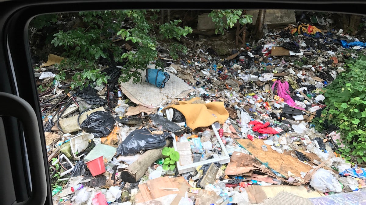  Trash near a heroin encampment is seen from a Conrail vehicle on Thursday. (Joel Wolfram / WHYY) 