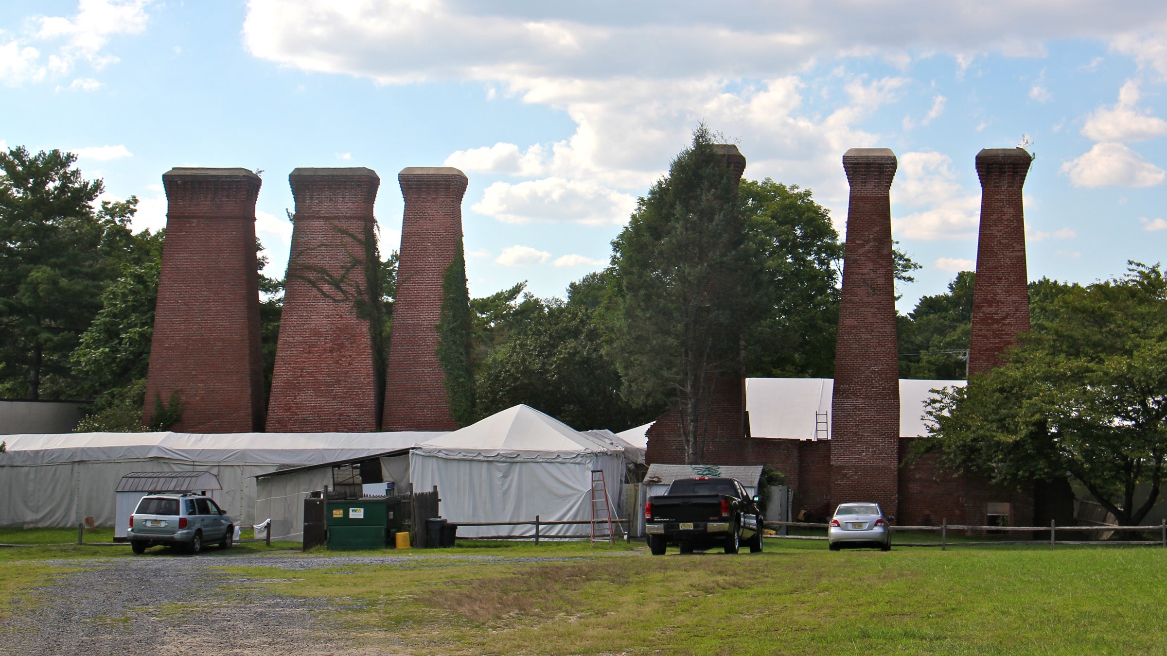 The smokestacks of the former Lucas paint factory loom over the Sherwin-Williams/Hilliards Creek Superfund site in Gibbsboro, New Jersey. Contamination at the site stems from improper paint disposal by Lucas Paint Works and its successor, Sherwin Williams Inc. (Emma Lee/WHYY) 