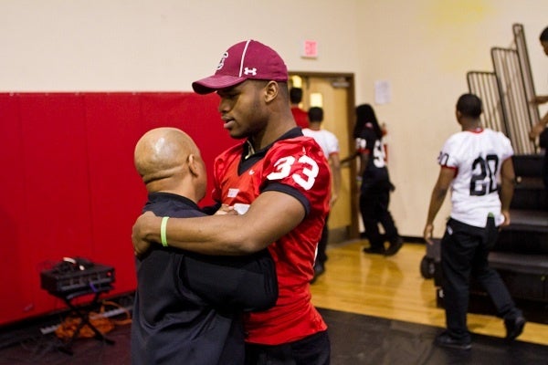<p><p>Running back David Williams and Coach Albie Crosby hug after Imhotep's National Signing Day event on Wednesday morning. They were together at West Catholic prior to Imhotep. (Brad Larrison/for NewsWorks)</p></p>
