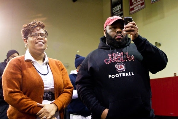 <p><p>David Williams' mother and godfather, Tamara Bunch and Rodney Veney, looked on and took pictures of the newest South Carolina Gamecock on Wednesday. (Brad Larrison/for NewsWorks)</p></p>
