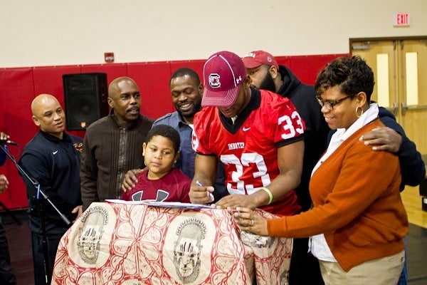 <p><p>David Williams stands next to his mother Tamara and other family members while signing with the University of South Carolina. His mom said the choice was between two schools from which coaches thought to visit her. (Brad Larrison/for NewsWorks)</p></p>
