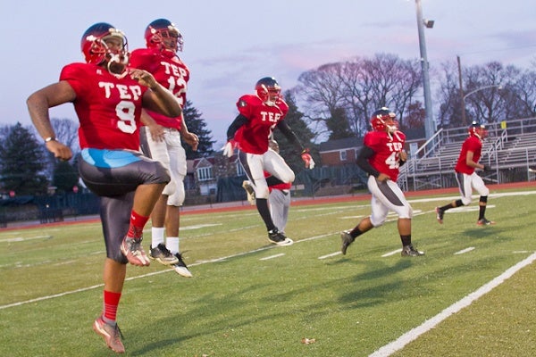 <p><p>At practice, Imhotep's players on defense wear red while the offense wears black. (Brad Larrison/for NewsWorks)</p></p>
