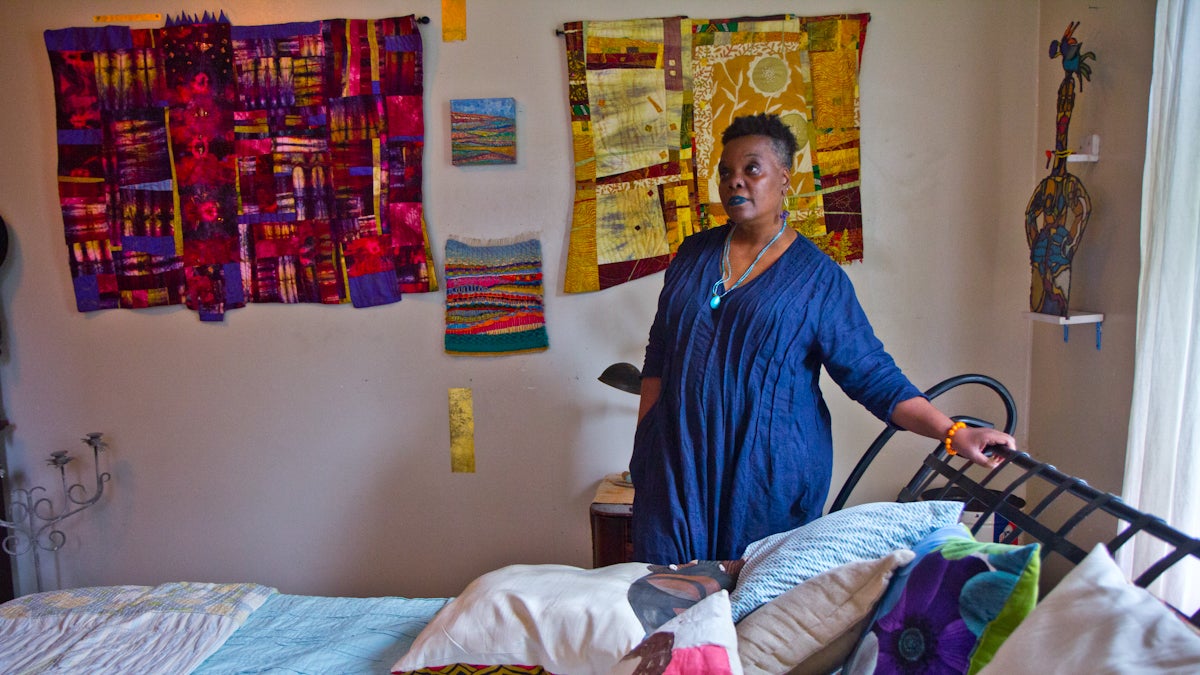 Vashti DuBois stands over her bed. (Kimberly Paynter/WHYY)