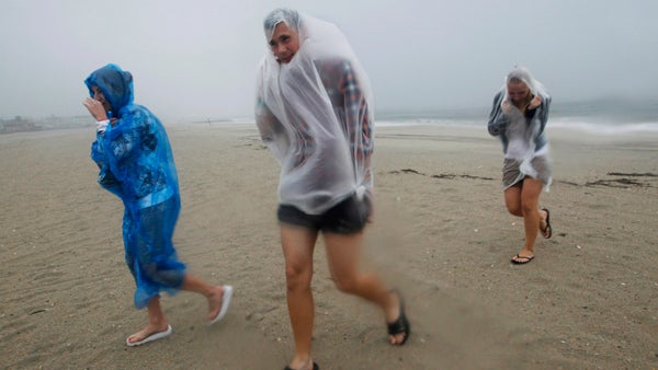  Xenia Semenova, right, 21, of Russia, Sergey Moiseev, 19, of Russia, and Natalia Aliakseyeva, 24, of Belarus, walk on the beach against strong winds Saturday, Aug. 27, 2011, in Cape May, N.J., as Hurricane Irene approaches. (Mel Evans/AP Photo) 