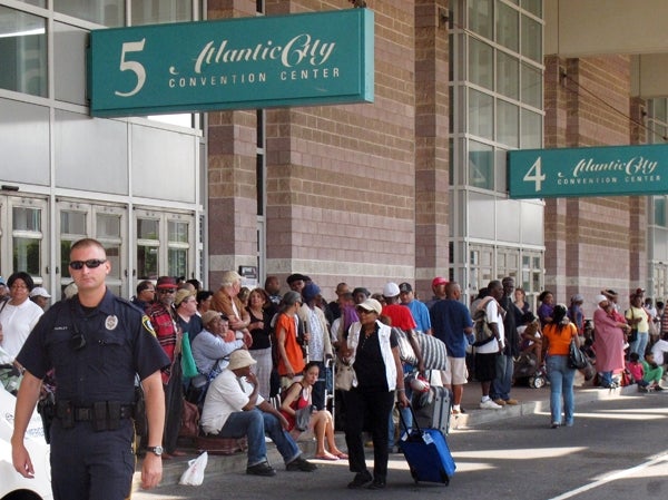 A police officer is on crowd-control duty outside the Atlantic City Convention Center, which is being used as an evacuation center for hundreds of city residents fleeing the approach of Hurricane Irene. (AP Photo/Wayne Parry)