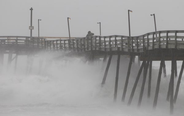 In the Outer Banks of N.C., a fishing pier looses pilings. On Saturday night, Atlantic City, N.J., and other evacuated shore towns stood in the path of the hurricane. (AP Photo/Charles Dharapak)