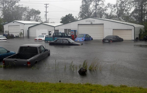 Vehicles sit in flood waters at a auto repair shop in North Carolina on Saturday. Phila. Nutter and other officials are extremely worried about regional flooding. (AP Photo/Chuck Burton)