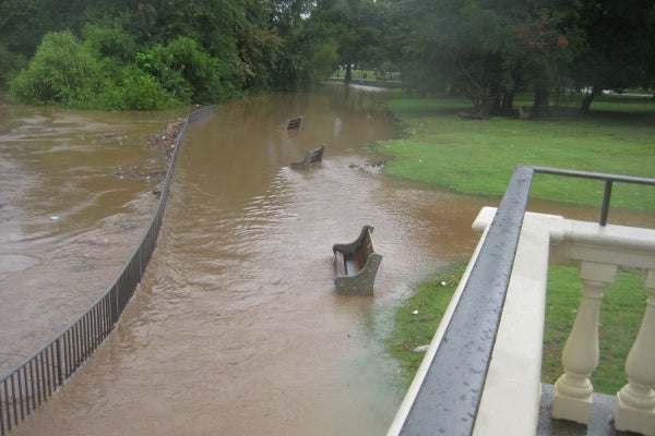 Water has reached benches, nearly covering one of them on the pier at Fairmount Water Works. (Maiken Scott/For NewsWorks)