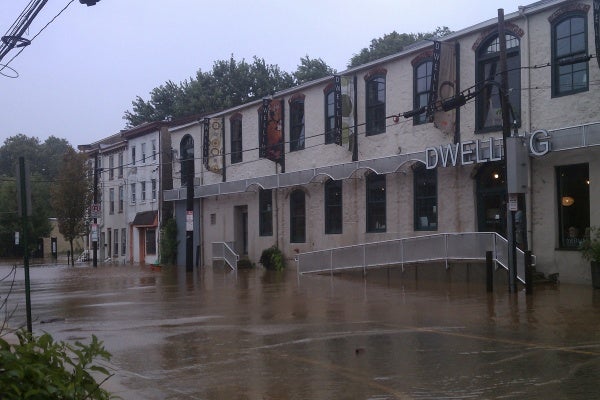 Flooding could be seen in Manayunk Sunday in front of this building at the intersection of Shurs and Main Street. (Megan Pinto/For NewsWorks)