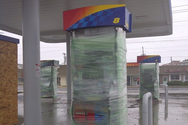 Some gas pumps in New Jersey were wrapped with plastic for proection from the hurricane. (Tom MacDonald/For NewsWorks)