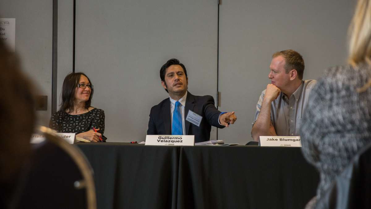  At the second annual Keystone Crossroads Urban Ideas Worth Stealing conference in Harrisburg, Guillermo Velazquez (center), chair of the Latino Business Initiative of the Pittsburgh Metropolitan Area Hispanic Chamber of Commerce, discusses immigrants starting small businesses. (Lindsay Lazarski/WHYY) 