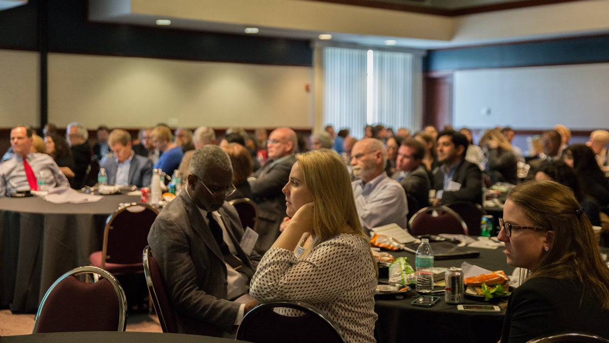  Hilary Coulson (center), a history professor at Harrisburg University listens to a lunch time panel discussion with three mayors from Pennsylvania cities: Lancaster Mayor Rick Gray, Braddock Mayor John Fetterman, and Altoona Mayor Matt Pacifico at the Keystone Crossroads’ Urban Ideas Worth Stealing conference. (Lindsay Lazarski/WHYY) 