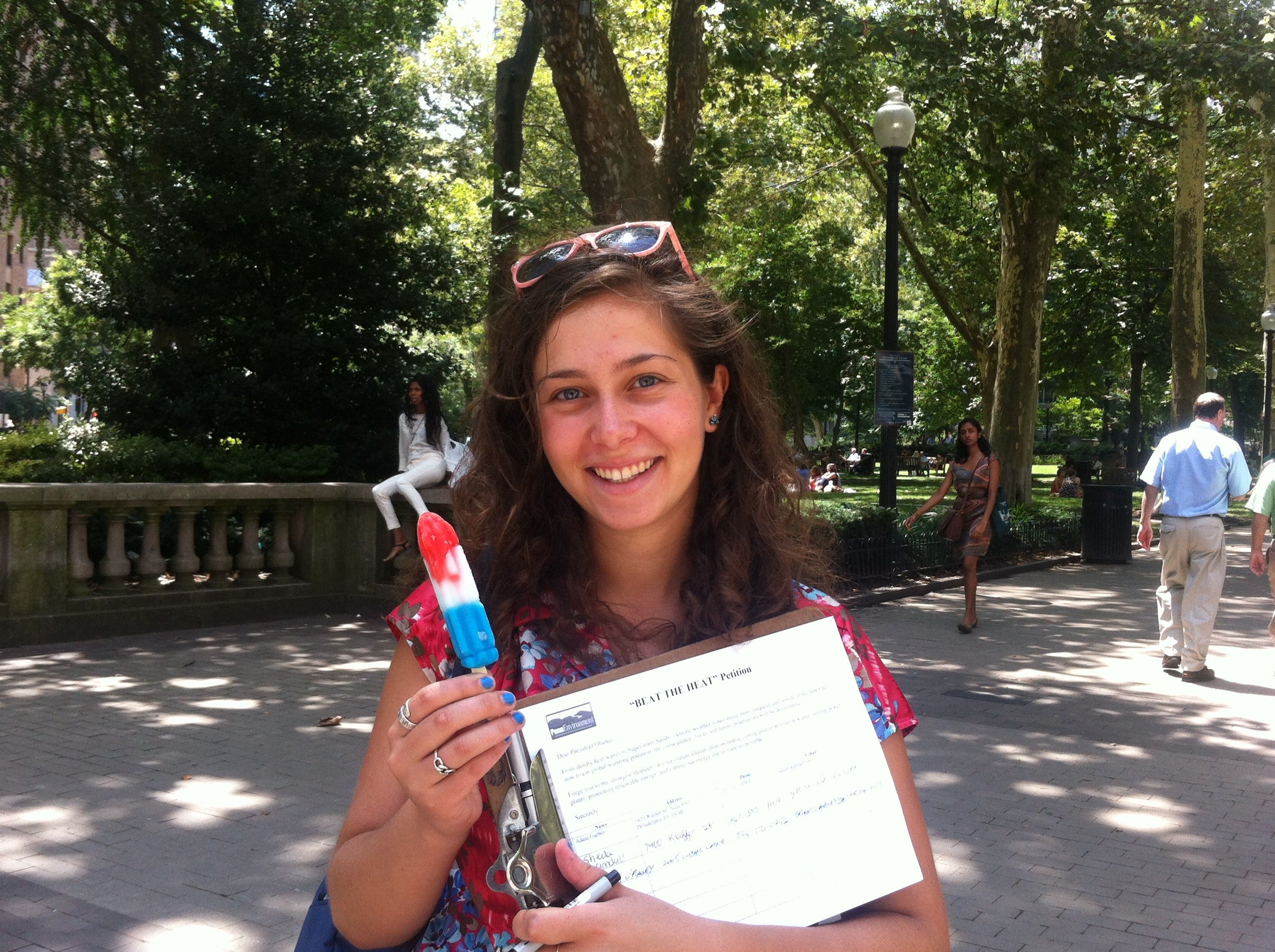  Pictured: Isabella Levy, intern for PennEnvironment. The group used a timely tactic - popsicles - to get people's attention about global warming. (Meg Frankowski/for NewsWorks) 