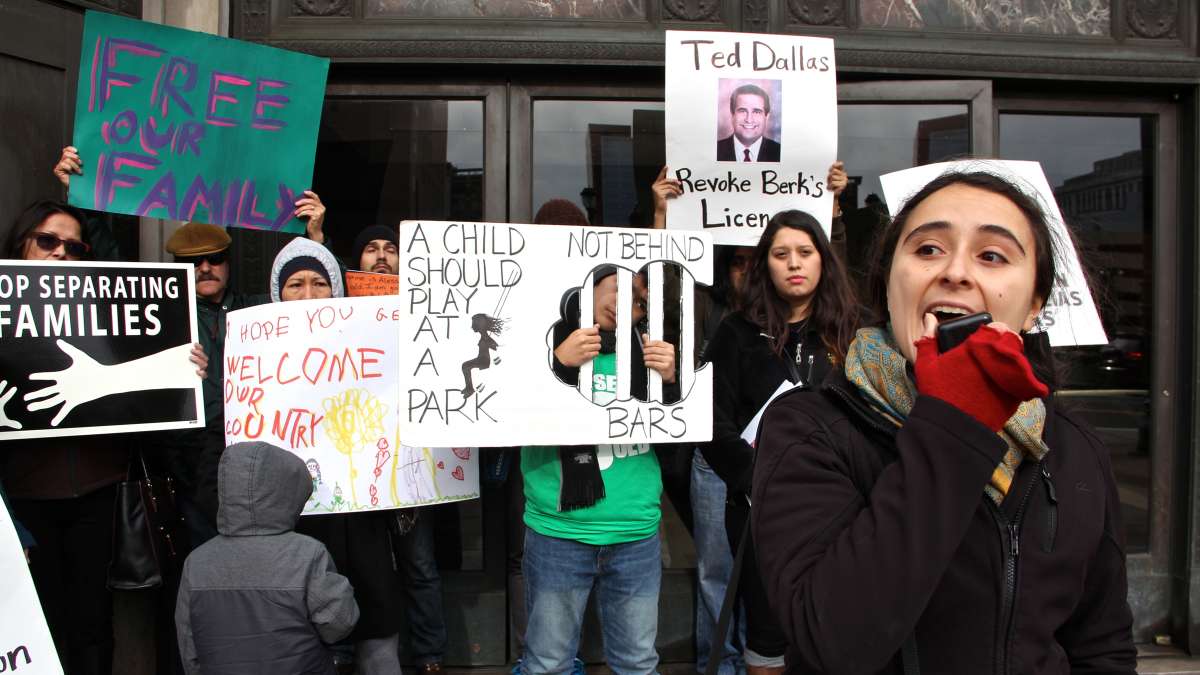 Yared Portillo of Juntos speaks at a rally outside 801 Market St. to call for the closing of the Berks County Residential Center, one of three centers in the country used to detain families whose immigration status is undetermined. (Emma Lee/WHYY)
