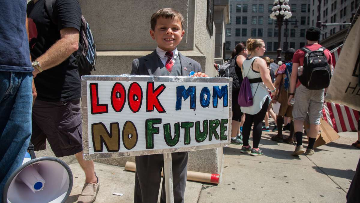 Connor Garrett, 9, protests for Bernie Sanders with his dad. They traveled from Connecticut to attend the rallies during the Democratic National Convention in Philadelphia.