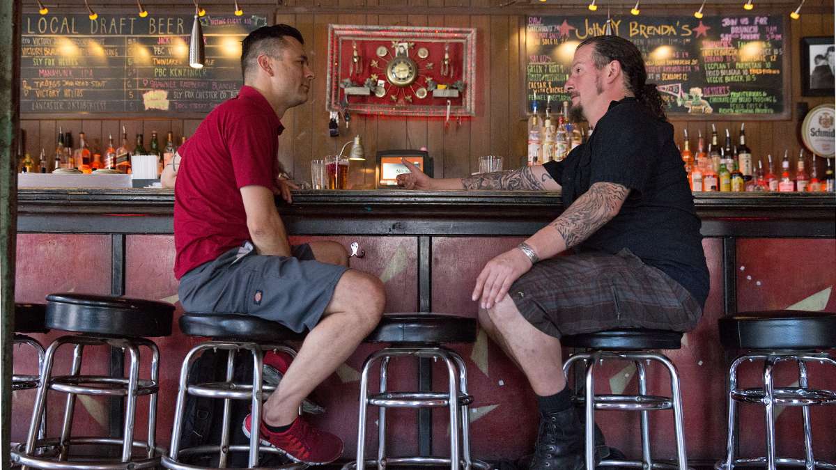Bob Achilles (left) and Erik Boardman have a drink at Johnny Brenda's before starting their bartending shifts at another Fishtown pub. (Lindsay Lazarski/WHYY)