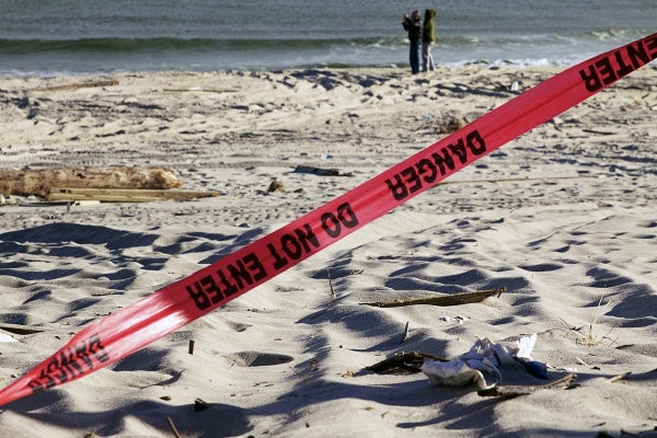 <p>A couple defies warnings to stay off the beach to get a better look at the storm ravaged boardwalk. ( Jana Shea /for NewsWorks )</p>
