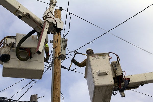 <p>Utility workers from KDM Powerline Construction in Gilbert, Louisiana help to restore electricity. ( Jana Shea /for NewsWorks )</p>
