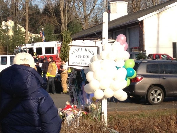 <p><p>At Sandy Hook Elementary School, Newtown residents offer flowers and balloons in remembrance of the victims. (Photo courtesy of Monika Gupta)</p></p>
