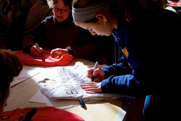 <p>Many of the volunteers hand printed the victims' names on t-shirts.  ( Jana Shea /for NewsWorks )</p>
