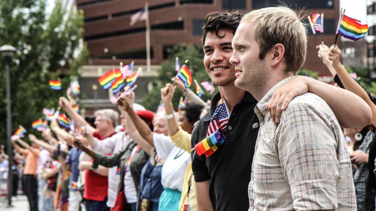 Felix Vazquez and Bryan Kerr attend Philadelphia's 4th of July celebration of the 50th anniversary of the LGBT civil rights movement. (Kimberly Paynter/WHYY)