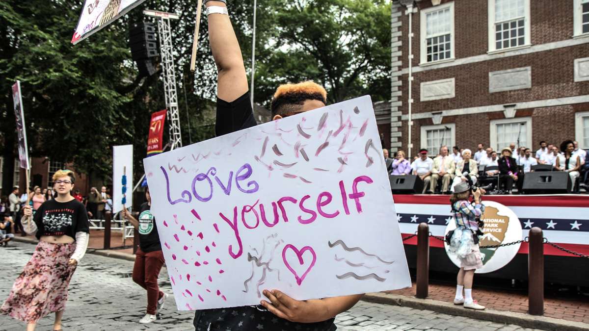 LGBT youth picket for equal rights and understanding at Philadelphia's 4th of July celebration of the 50th anniversary of the LGBT civil rights movement. (Kimberly Paynter/WHYY)