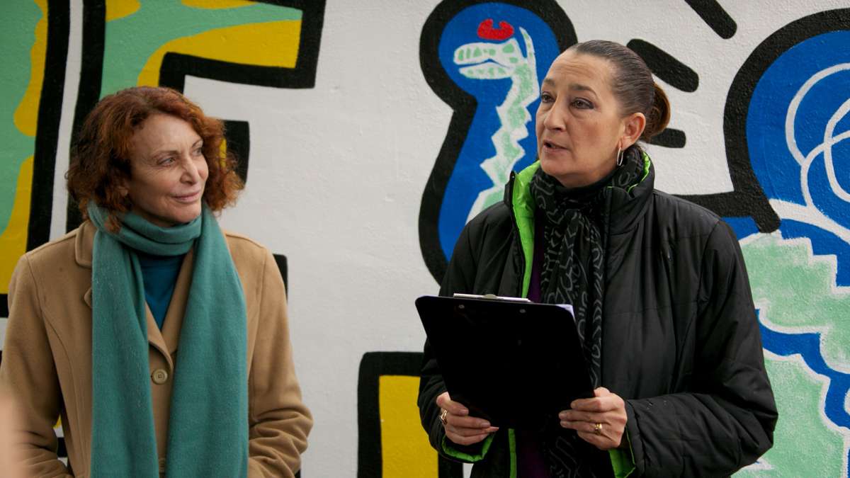 Jane Golden, Executive Director of The City of Philadelphia Mural Arts Program, celebrates the reopening with Julie Gruen, Executive Director of The Keith Haring Foundation.