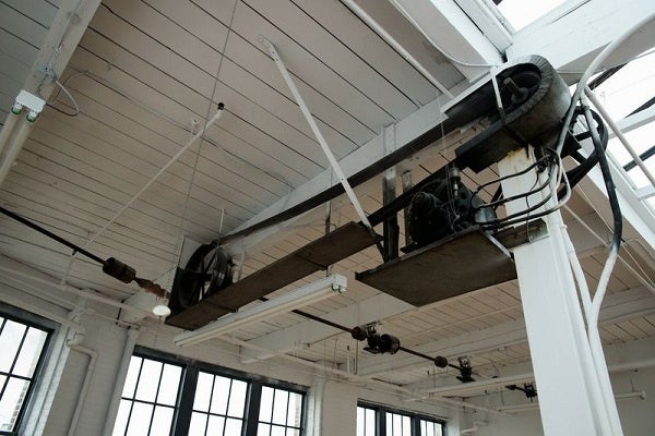<p><p>In many of the units, ceiling-mounted iron gears and other features left over from the mill's past remain. (Bas Slabbers/for NewsWorks)</p></p>
