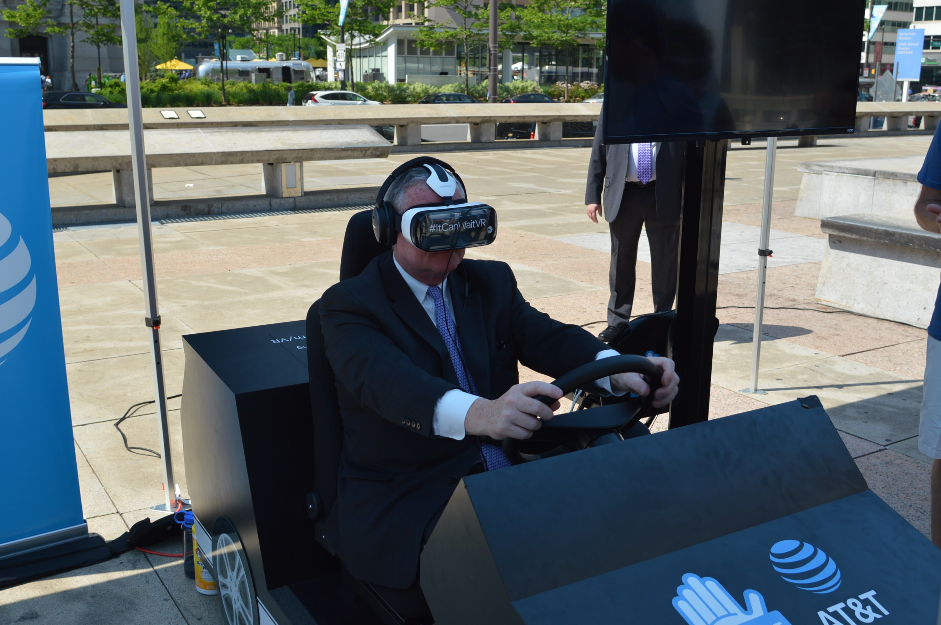  Mayor Jim Kenney tries out a virtual car for a  demonstration of distracted driving. (Tom MacDonald/ WHYY) 