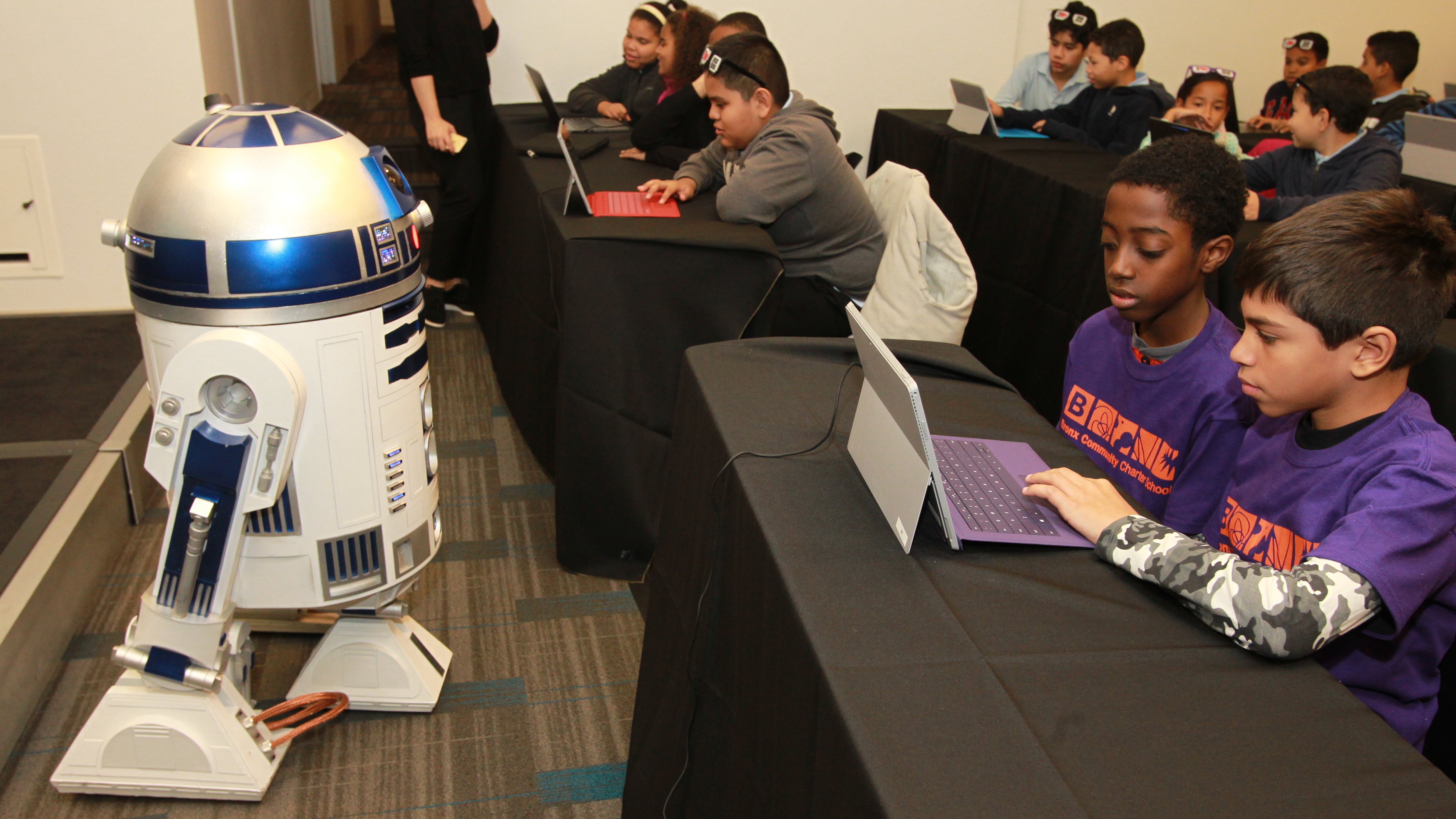  R2-D2 joins New York City students at an Hour of Code pep rally hosted by Code.org, Microsoft and Google at Nasdaq MarketSite in 2015. Students were inspired to try coding with Minecraft and Star Wars themed tutorials. (Donald Traill/ AP Images for Microsoft) 