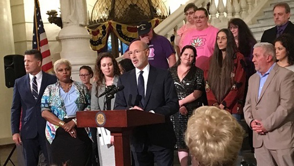  Governor Tom Wolf (center) and medical marijuana advocates celebrate the one-year anniversary of the legalization. (Katie Meyer/WITF) 