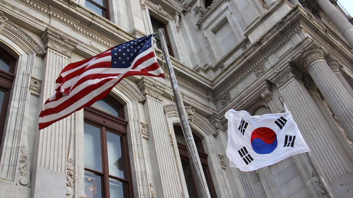 The American flag and the flag of the Republic of Korea fly side-by-side at City Hall in honor of Korean American Day.