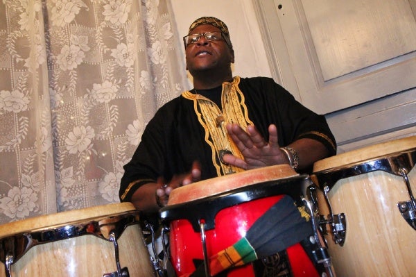 <p><p>Baba Garland M. Franklin, a percussionist with Temple University's Pan-African Studies Community Education Program (PASCEP), drums at the Johnson House Kwanzaa celebration. (Kimberly Paynter/WHYY)</p></p>
