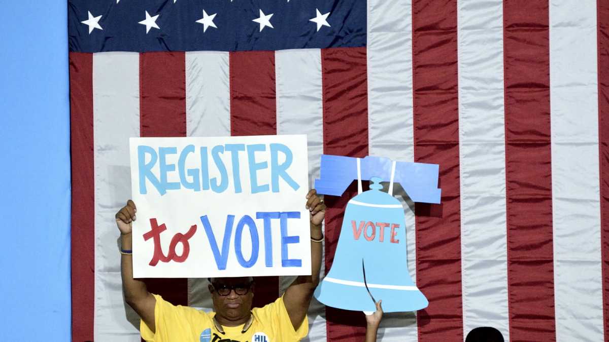  Participants carry signs at a voter registration event in held in August, 2016.(Bastiaan Slabbers/for NewsWorks) 
